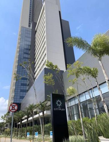 a tall building with a sign in front of it at Dream House - Studio Premium, Piscina, Sauna e Garagem in Osasco