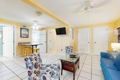 a living room with a blue couch and a table at Duval Street Retreat in Key West