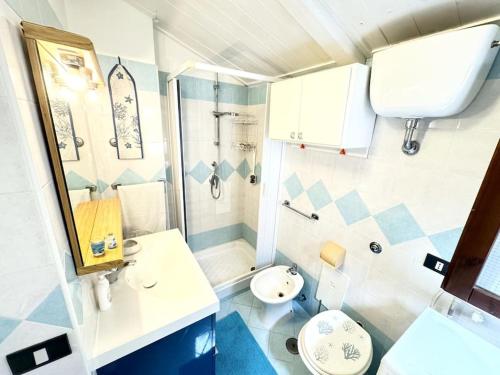 a bathroom with a sink and a toilet and a shower at Casa Marilyn in Ascea