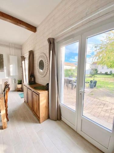 a room with a sliding glass door to a patio at Charmante maison familiale -Jardin -WIFI -Parking in Mérignac