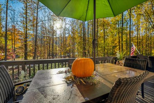 a pumpkin sitting on top of a table with an umbrella at Herons Rest -- Riverfront, Fire Pit, All seasons Porch, Grill, Games, Fishing, Deck, Wifi, River view in Great Cacapon