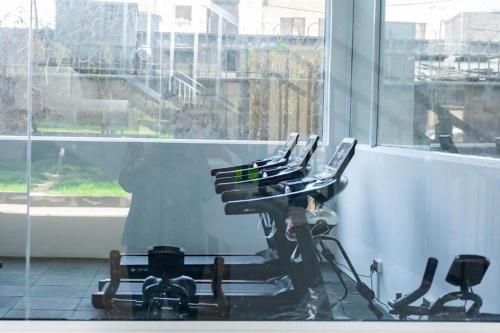 a row of chairs in a room with a window at Imagine Luxury Apartments in Nairobi