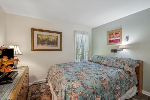 a small bedroom with a bed and a window at Herons Rest -- Riverfront, Fire Pit, All seasons Porch, Grill, Games, Fishing, Deck, Wifi, River view in Great Cacapon
