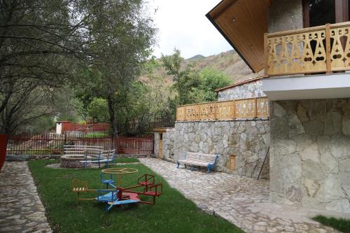 a yard with three picnic tables and a bench at Meghu Guest House in Aghavnavankʼ