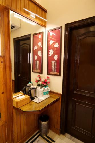 a bathroom with a counter with flowers on it at Wood Castle in New Delhi