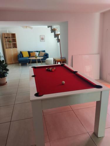 a red pool table in a living room at chambre soleil in La Ciotat