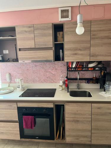 a kitchen with a sink and a stove at Departamento Centro en Temuco in Temuco