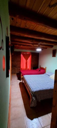 a bedroom with two beds in a room at Cabañas Clarita in Dina Huapi
