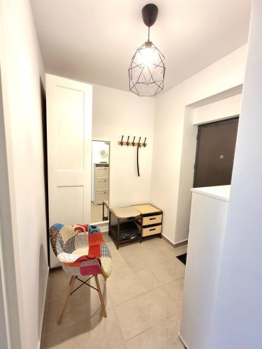 a living room with a table and a chair at Marianne, Apartament 2 Camere, Morii Lake 2 in Bucharest