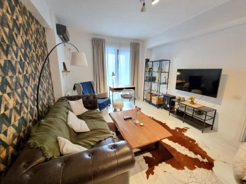 a living room with a couch and a coffee table at Marianne, Apartament 2 Camere, Morii Lake 2 in Bucharest