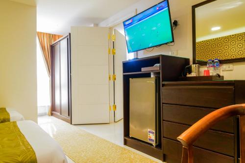 a room with a bed and a tv on a wall at Royal Day in 6th Of October