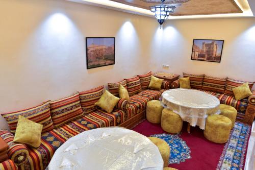 a living room with a couch and a table at Dar Chams Ouarzazate in Ouarzazate