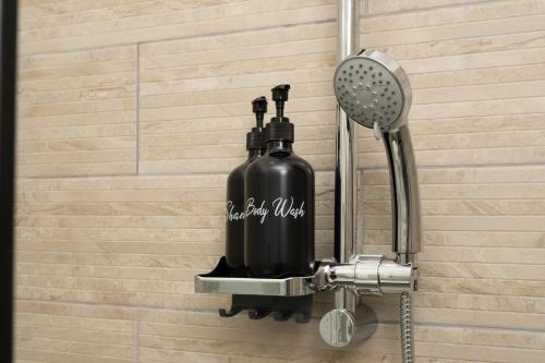 a bathroom with a soap dispenser on a wall at Fix You Apartment Fco 2 in Fiumicino
