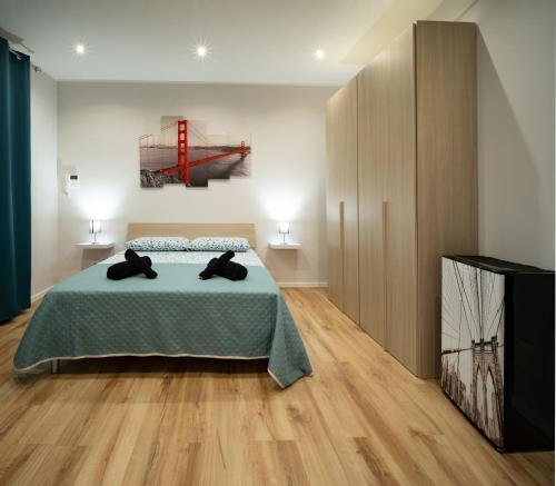 a bedroom with a bed with a green bedspread at Fix You Apartment Fco 2 in Fiumicino