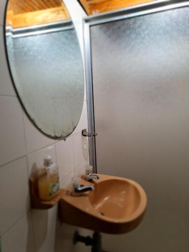 a bathroom with a sink and a mirror at Hostal Prana in Abejorral