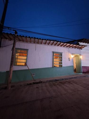 a white building with two windows and a door at Hostal Prana in Abejorral
