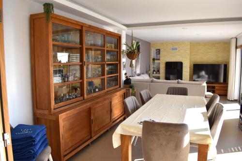 a dining room with a china cabinet and a table at Casa da Vitoria in Falca