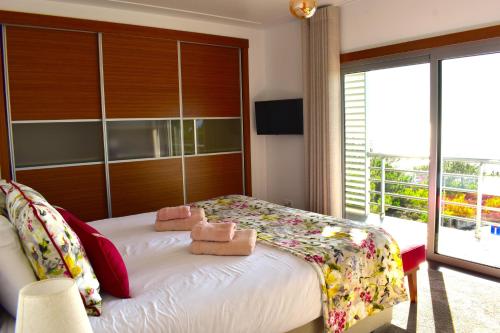 a bedroom with a bed with two teddy bears on it at Casa da Vitoria in Falca