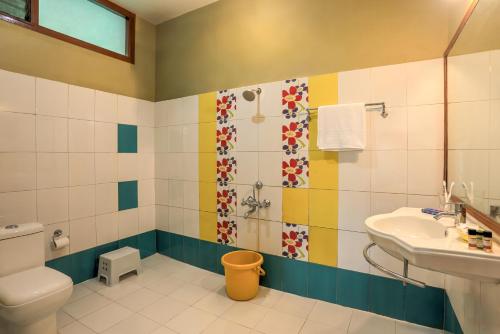 a bathroom with a sink and a shower and a toilet at Royal Woods Coorg in Madikeri