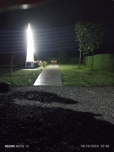 a lit up monument in a park at night at HARMONY- ჰარმონია in Ambrolauri