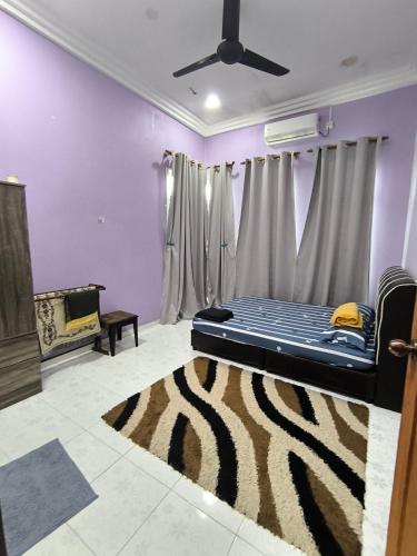 a room with a bed with a zebra rug at Tiffana Homestay in Kampong Ayer Terjun