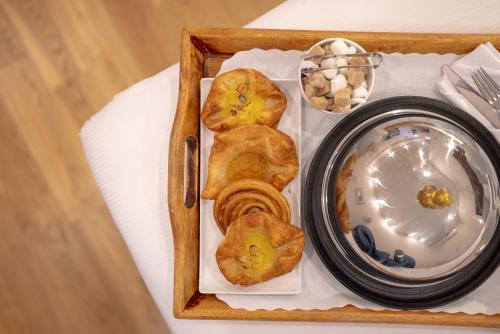a tray of food with pastries and a plate at County Hotel in Chelmsford