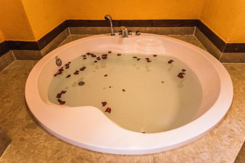 a bath tub filled with blood on the floor at Gucheng Lanshe Designer Garden B&B in Lijiang