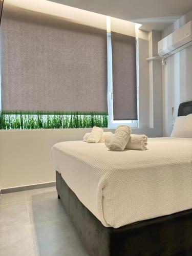a bedroom with a large bed with a window at JV Athens in Athens
