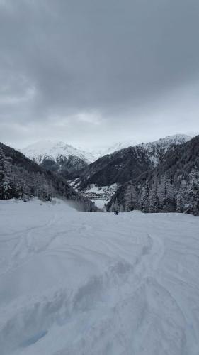 a person standing on top of a snow covered field at Pink Grumello in Schilpario