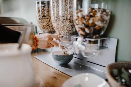 a person is mixing food in a bowl on a counter at Stadsherberg de Wijnberg in Bolsward