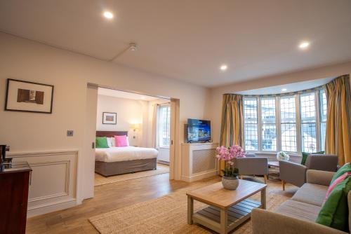 a living room with a bed and a couch at County Hotel in Chelmsford