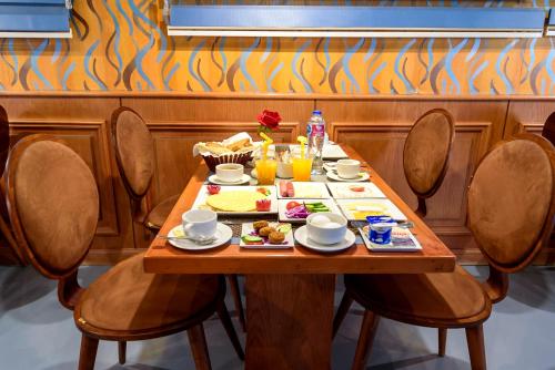 a wooden table with food and drinks on it at Royal Day in 6th Of October