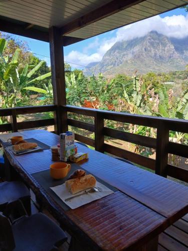 a table with food on it with a view of a mountain at Hiva oa chalets in Atuona
