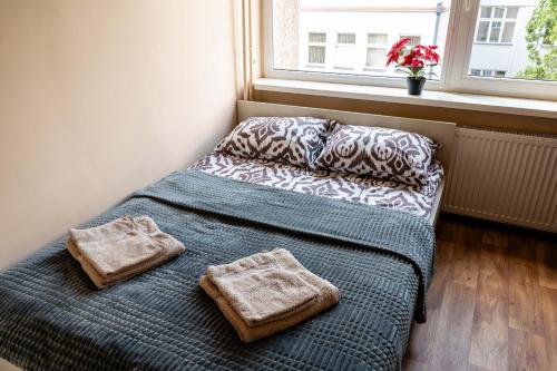 a bed with two towels on it in a bedroom at Studio Apartment in Kaunas