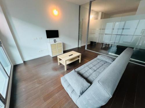 a living room with a couch and a table at De Madrid al cielo suites con wifi y Netflix in Madrid