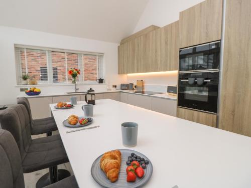 a kitchen with a table with a plate of food on it at Low Tide Loft in Freshwater