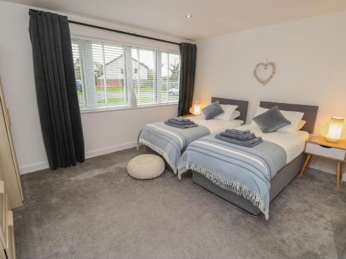 a bedroom with two beds and a window at Low Tide Loft in Freshwater