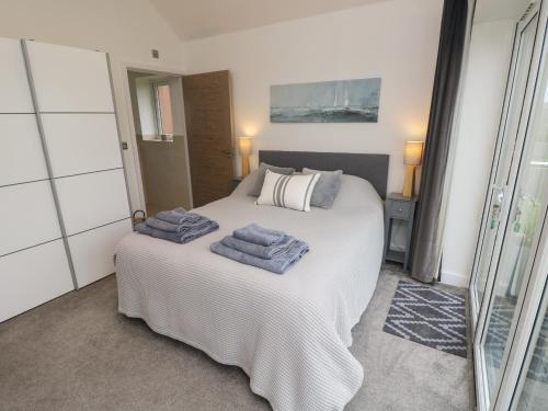 a bedroom with a bed with towels on it at Low Tide Loft in Freshwater
