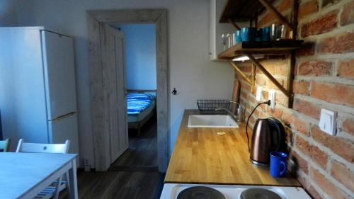 a small kitchen with a sink and a refrigerator at Apartment Polianka in Vysoké Tatry