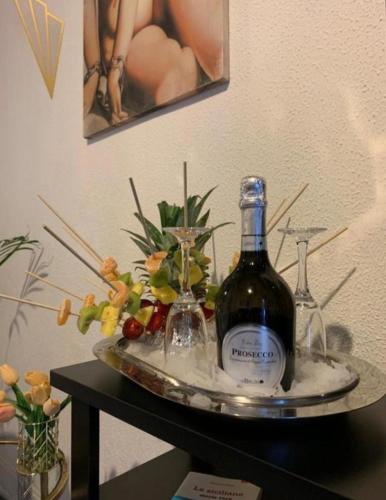 a bottle of wine and two glasses on a table at Morosoli Spa in Catania
