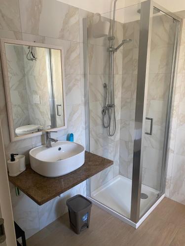 a bathroom with a sink and a shower at VILLA MANIVA in Ginosa Marina