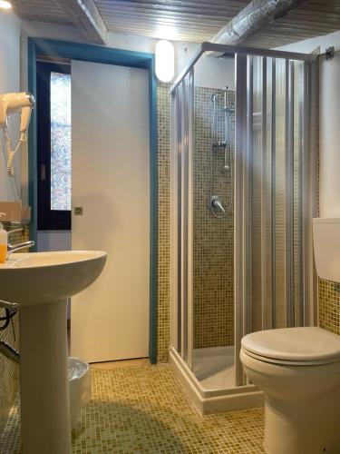 a bathroom with a shower and a toilet and a sink at casa catania termini home 4 in Catania