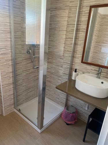 a bathroom with a shower and a sink at VILLA MANIVA in Ginosa Marina