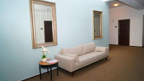 a living room with a couch and a table at Hotel Class in Hamburg