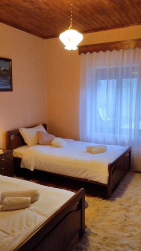 a bedroom with two beds and a window at Rustic House in Miléa