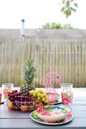 a table topped with plates of fruit and a bowl of pineapple at Serenity by the Sea Heated Pool and Spa in Apollo Beach