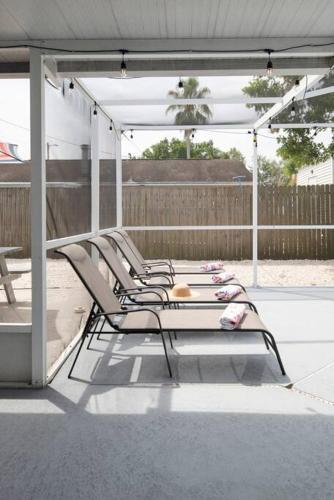 a group of chairs sitting on a patio at Serenity by the Sea Heated Pool and Spa in Apollo Beach