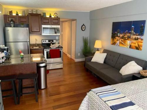 a living room with a couch and a kitchen at Condo Close to Stadium and Free Parking in Knoxville