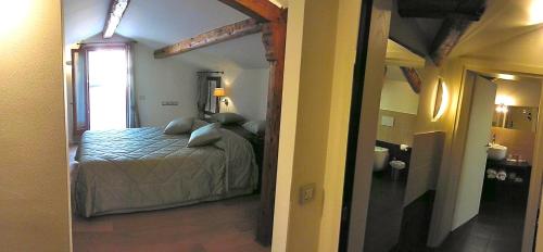 a bedroom with a bed and a room with a window at Hotel Sant'Antonin in Venice