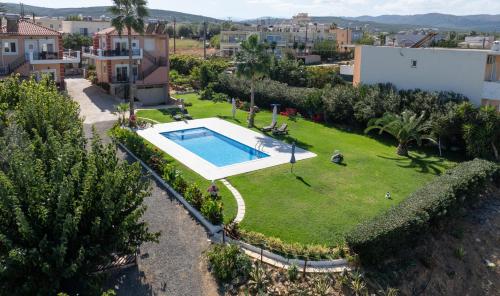an aerial view of a yard with a swimming pool at Socrates Holidays Apt. 2 with Pool near the Beach in Plataniás